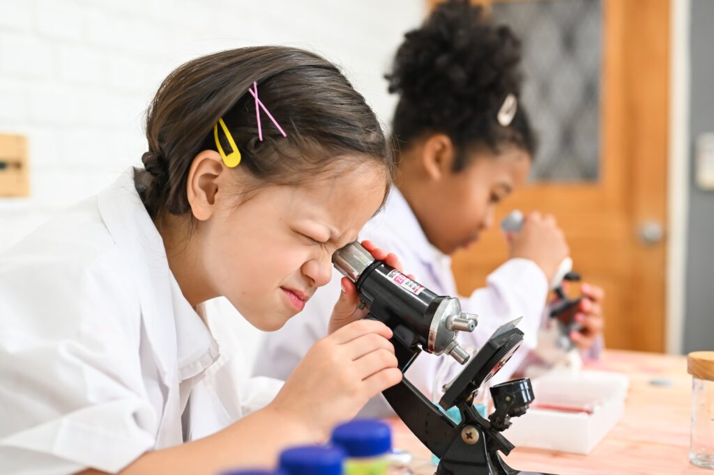 Child in classroom at school, Kid dressed science lab coat, Science concept
